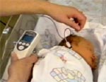 a nurse testing a baby's hearing